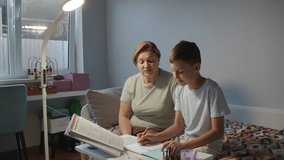 Grandmother helping grandson with homework at home - Powered by Shutterstock - Get 15% off with code: PIKWIZARD15