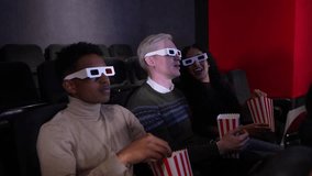 Young couple wearing 3d glasses, eating popcorn and enjoying a movie at the cinema in slow motion - Powered by Shutterstock - Get 15% off with code: PIKWIZARD15