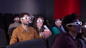 Couple enjoying a 3d movie at the cinema, sharing popcorn and pointing at the screen in slow motion - Powered by Shutterstock - Get 15% off with code: PIKWIZARD15