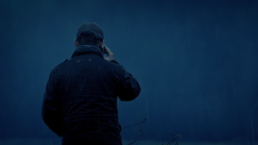 Anonymous Man On Phone In The Rain Ominous Scene