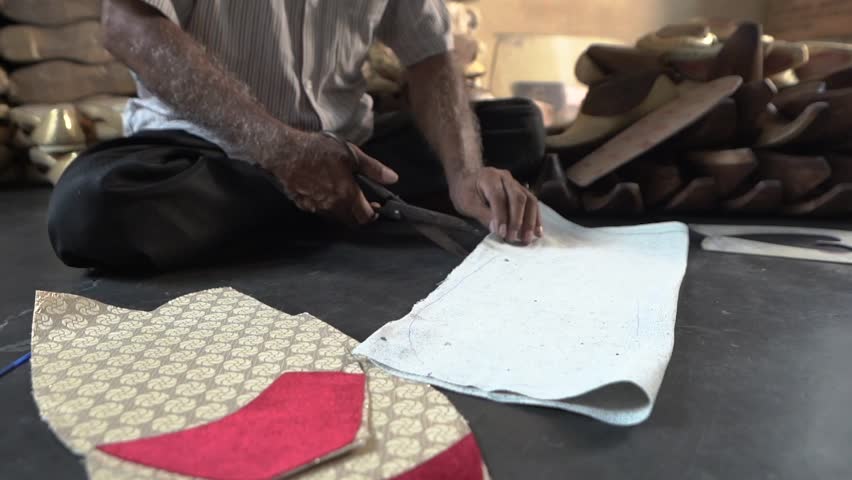 Man making traditional Indian foot wear. Indian Punjabi jutti.