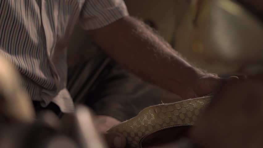 Man making traditional Indian foot wear. Indian Punjabi jutti.
