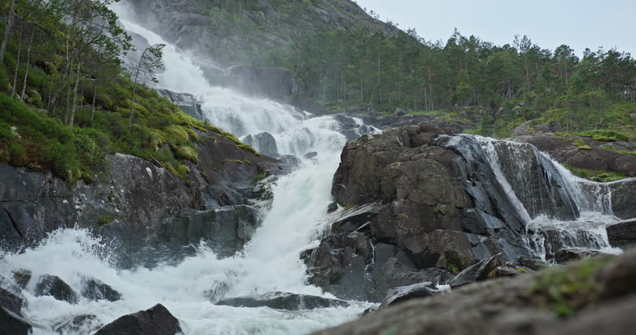Powerful cascade at Langfossen waterfall, Akrafjorden Norway, wide multi tier view