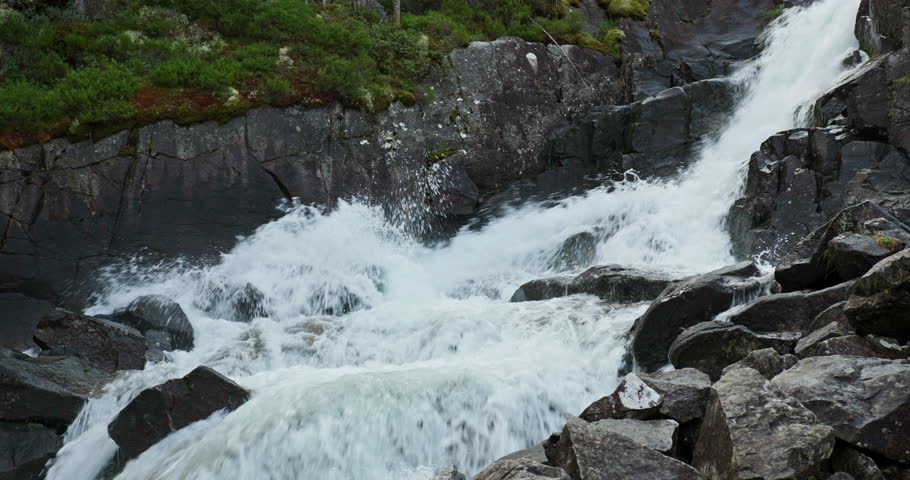 Raging whitewater at Langfossen waterfall, Akrafjorden, Norway, close up cascade over rocks