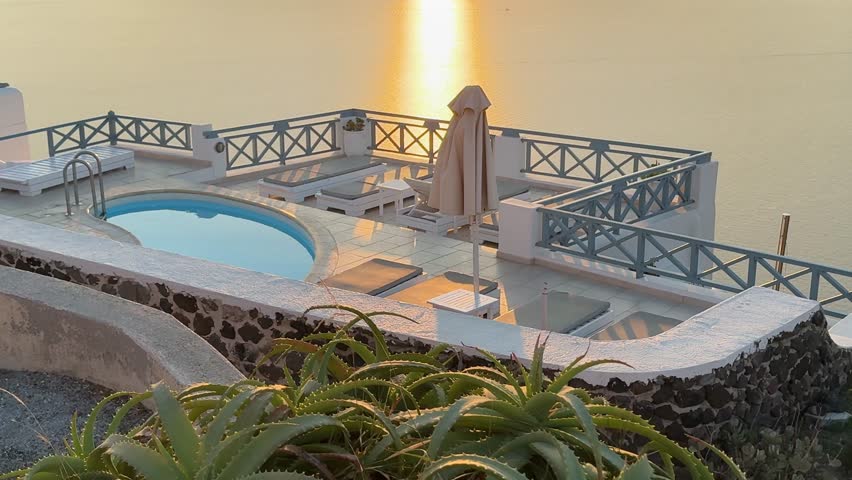 Beautiful sunset in Santorini island, Greece. Beautiful terrace with sea view. Blue sea and the blue sky at sunset. Summer travel and vacation. 