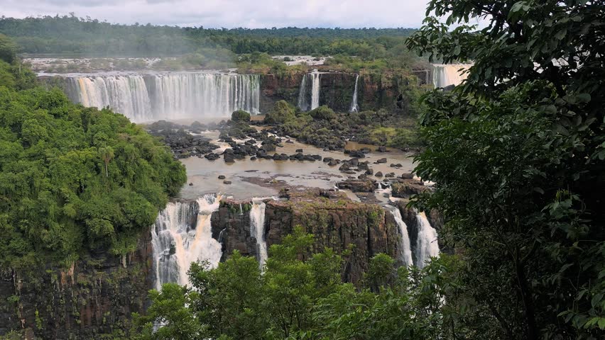 Iguazu Falls, waterfalls of Iguazu River on border of Argentine and Brazilian state of Parana. Panoramic view of magnificent natural wonder of the world. Brazil side. Brazilian wilderness landscape.
