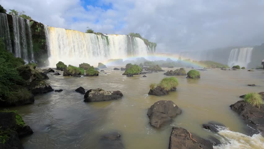 Iguazu Falls, waterfalls of Iguazu River on border of Argentine and Brazilian state of Parana. Panoramic view of magnificent natural wonder of the world. Brazil side. Brazilian wilderness landscape.
