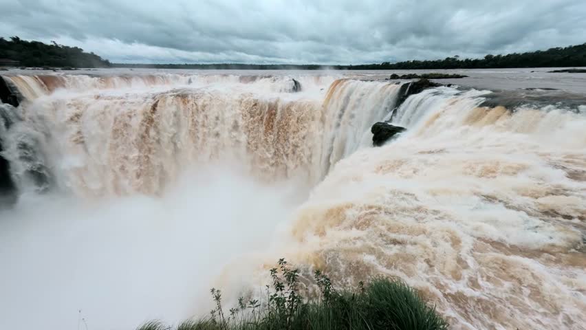 Iguazu Falls Devil Throat, world-famous waterfalls of Iguazu River on border Argentine province of Misiones and Brazil state Parana. Panoramic view of natural wonder. Brazilian wilderness landscape