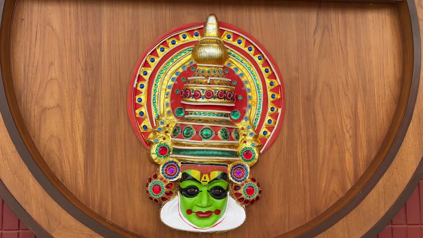 Handmade colourful kathakali mask on wall for decoration.