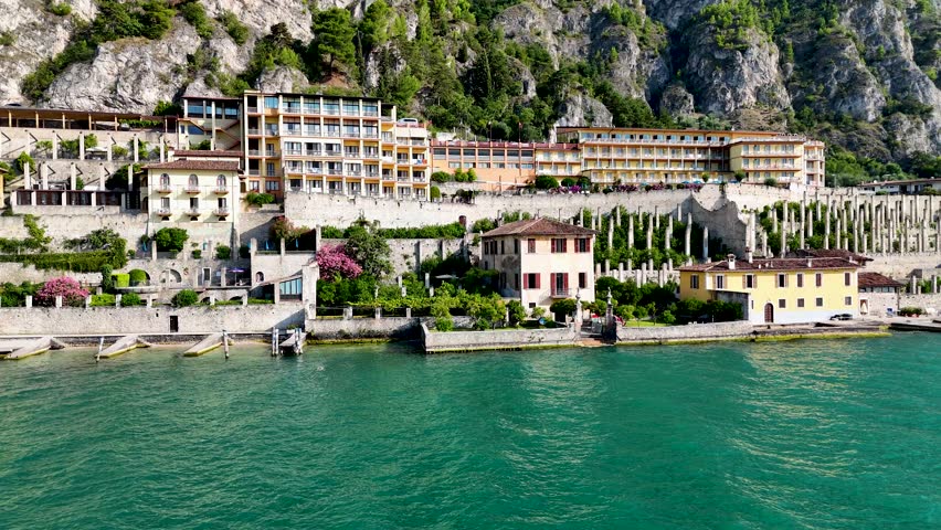 Limonaia - the lemon terraces of Limone sul Garda, Italy. Aerial 4K video footage of old lemon house in lake Garda. Drone view of lemon grove