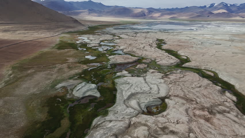 Salt Lake with Green Marshland and Mountains Drone View