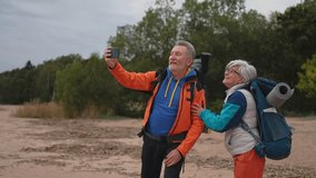 Hiking tourism adventure. Senior couple making selfie enjoying outdoor recreation hiking. Old people backpackers hikers taking photo enjoy walking hike trekking active vacation beauty of nature - Powered by Shutterstock - Get 15% off with code: PIKWIZARD15
