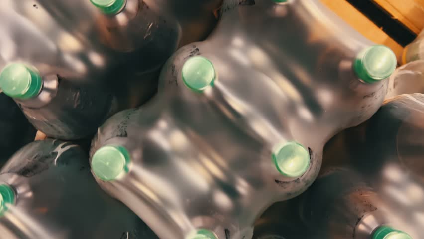 Top-Down View: Two-Liter Plastic Beverage Bottles Grouped in Six-Pack Blocks | Shrink-Wrapped Bundle Storage | Wholesale Food Warehouse Display