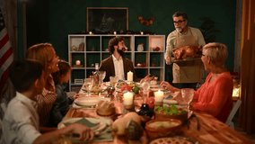 Elderly grandfather wearing classic apron, carefully carving roasted turkey, sharing festive holiday meal with multigenerational family gathered around dining table - Powered by Shutterstock - Get 15% off with code: PIKWIZARD15