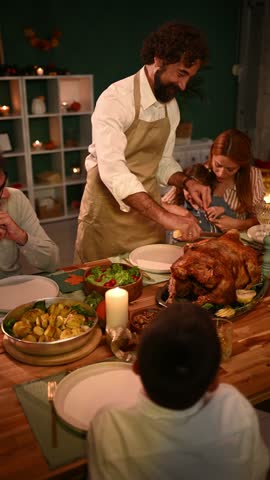Family gathered around dining table, father carving roast turkey, children watching in anticipation, warm and festive atmosphere