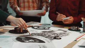 A group of engineers collaborates on aircraft engine design, examining technical drawings and components in a modern workspace filled with creativity and teamwork. SACTR - Powered by Shutterstock - Get 15% off with code: PIKWIZARD15