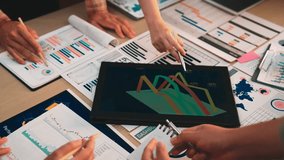 A dynamic business team collaborates on data analysis using a digital tablet. They discuss trends and performance metrics, enhancing strategic decision-making in a modern office. SACTR - Powered by Shutterstock - Get 15% off with code: PIKWIZARD15