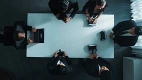 Top down aerial view of diverse data analysts wearing VR headset and stand around table while using hand gestures to manipulate the data streamed live from executive manager's laptop. Directorate. - Powered by Shutterstock - Get 15% off with code: PIKWIZARD15