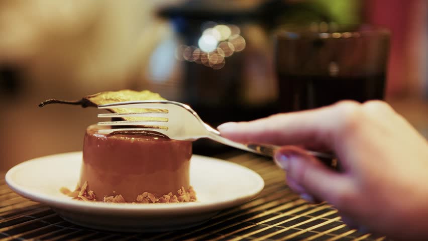 Gourmet Dessert With Caramel Glaze And Pear Garnish Being Enjoyed With  Fork. Sweet Treat In A Cozy Cafe Setting, Delicious Pastry On Plate. Fine Dining Yummy Dish, Cake Pastry. Coffee Break Dessert