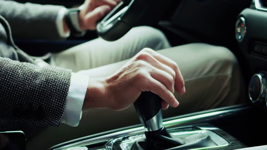 Shifting Gears In Modern Car, Professional Driver On Urban Commute. Business Transportation, Corporate Lifestyle Vehicle Interior, Luxury Travel. Business Trip, Road Commute. Driver Shifting Gears Car