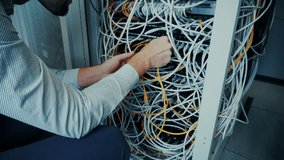 IT Technician Working With Tangled Cables. Network Infrastructure Maintenance In Server Rack, Data Center Technology, Messy Wires, Troubleshooting Connections. Network Specialist Ethernet Cables  - Powered by Shutterstock - Get 15% off with code: PIKWIZARD15