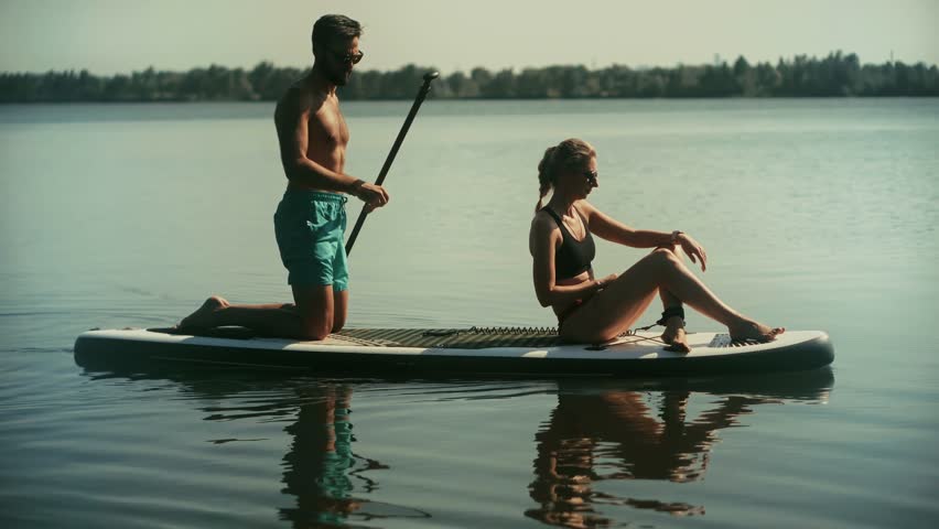 Couple On Paddleboard Sup On Calm Lake, Outdoor Recreation On Sunny Day, Summer Adventure On Water, Leisure Activity Sup Relaxing On River, Stand Up Paddleboarding Fun. Vacation Mood, Leisure Moment
