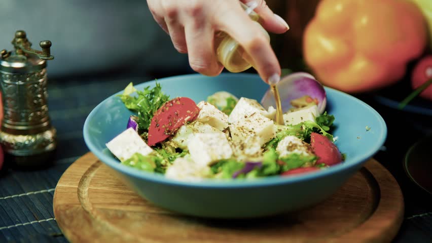 Chef Adding Spices And Olive Oil To Fresh Feta Salad, Healthy Vegetarian Meal Preparation, Home Cooking, Gourmet Food, Culinary Experience, Organic Ingredients. Delicious Recipe Healthy Eating Salad