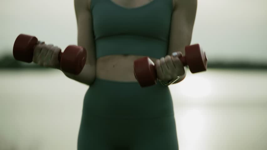 Dumbbell Curls. Female Athlete Training. Strength Workout Healthy Lifestyle Activity, Sporty Female Exercising, Physical Wellness. Mindful Movement, Outdoor Gym, Bicep Curls Upper Body Workout Sport