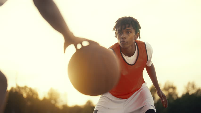 African american teen boy playing streetball with friend or brother, do sport. Portrait of emotional young sportsperson training and exercising, emotions in sport, active game, african basketballer