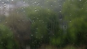 Rain Drops on Window Glass with Blurred Green Trees in Background
Close-up view of raindrops running down a windowpane during a rainy day, seen from indoors. - Powered by Shutterstock - Get 15% off with code: PIKWIZARD15