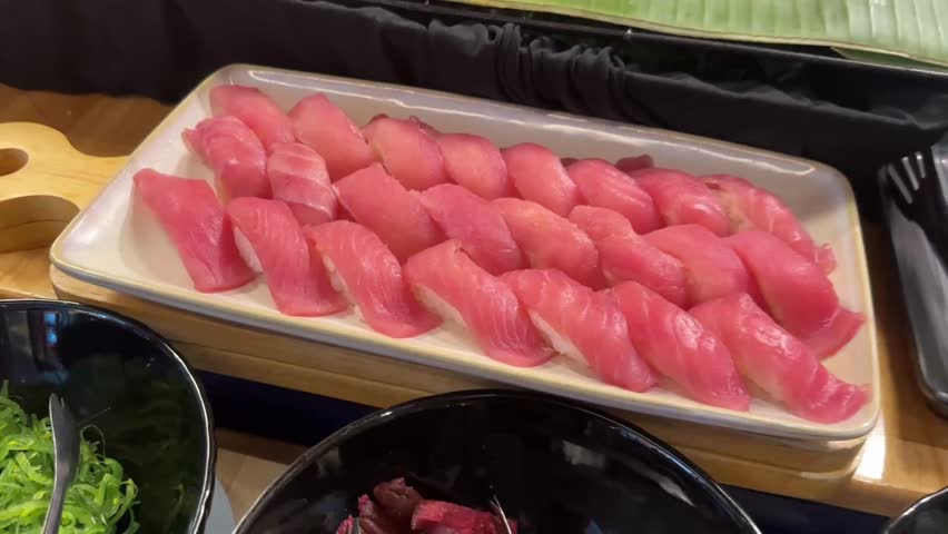 Tuna sushi with deep red fish slice on white rice shown in close-up with fresh detail