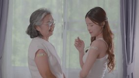 Happiness Asian senior woman and young woman are smiling happily with colorful bandages on upper arms after vaccination. Health protect to sick infectious diseases. happy health care. Build immunity
 - Powered by Shutterstock - Get 15% off with code: PIKWIZARD15