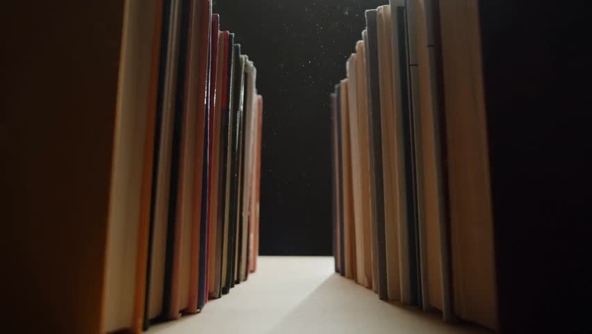Many old books in a library or bookshop, close-up and macro view, illustrating literature, education, research, archival collection, and historical knowledge.