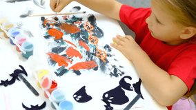 Child making pumpkins for the holiday of halloween. Funny crafts from paper. Halloween decor. Handicraft. The concept for Halloween. DIY. Children's art project, a craft for children. - Powered by Shutterstock - Get 15% off with code: PIKWIZARD15