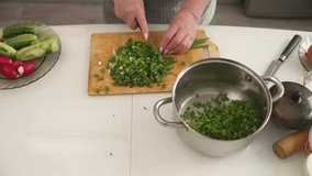 Green onions getting chopped on wooden cutting board, freshly diced scallions falling into stainless steel cooking pot with professional precision - Powered by Shutterstock - Get 15% off with code: PIKWIZARD15