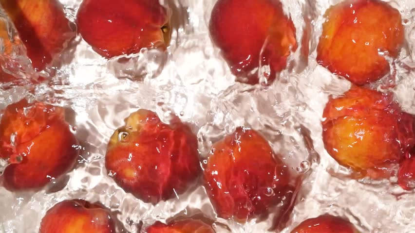 Top View of Ripe Peaches Floating in Water with Ripples Slow Motion - Powered by Shutterstock - Get 15% off with code: PIKWIZARD15