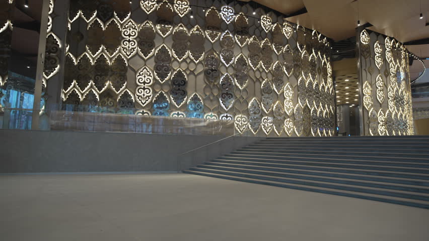 Decorative partitions enriched with Tatar patterns brighten theater hall. Ceiling resembles scattered sheets forming surreal landscape