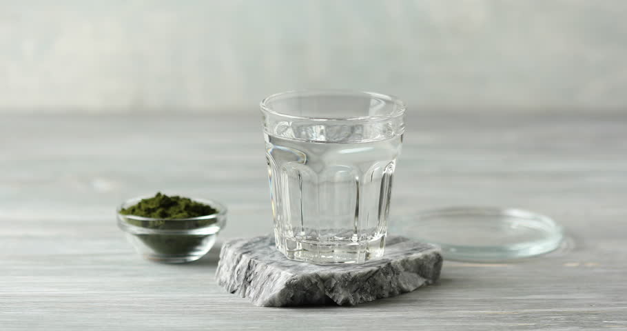 Chlorella algae powder dissolved in water in a glass