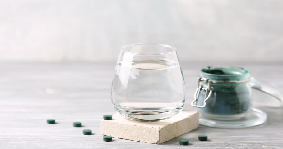 Spirulina algae powder dissolved in water in a glass