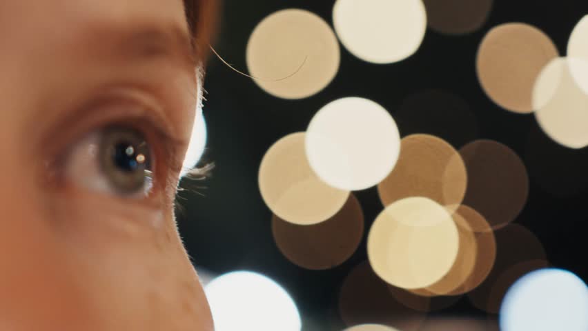 Child looking up in wonder at christmas lights montage