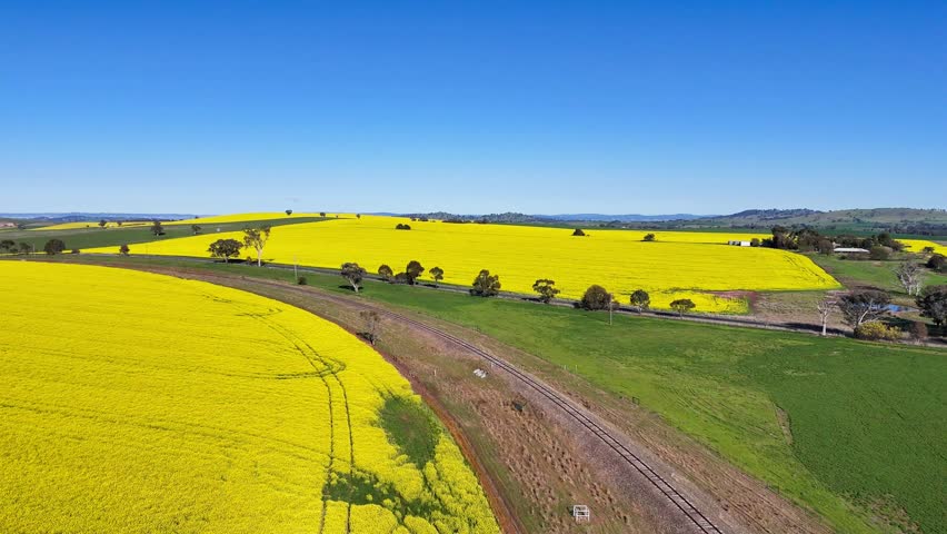 Aerial views of the disused Blayney-Demondrille Railway line and surrounding agricultural fields near Woodstock in New South Wales