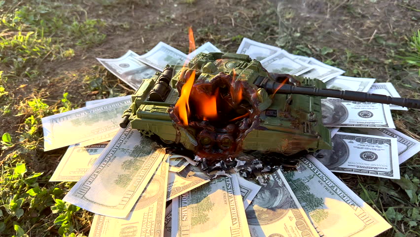 Battle tank on US dollar banknotes during burning. War costs, military spending. Money laundering on War. Battle toy tank on American Dollars banknotes in burning. American Military budget. Defence