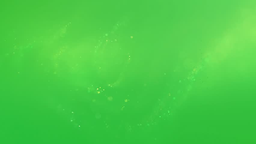 An animation of small glowing particles of light drift in a hazy, abstract cloud on a green screen background.