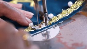 Detailed shots of hands meticulously creating intricate gold and pearl embroidery on fabric, followed by hands setting up a modern sewing machine for textile work. Perfect for showcasing craftsmanship - Powered by Shutterstock - Get 15% off with code: PIKWIZARD15