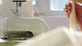 Detailed shots of hands meticulously creating intricate gold and pearl embroidery on fabric, followed by hands setting up a modern sewing machine for textile work. Perfect for showcasing craftsmanship - Powered by Shutterstock - Get 15% off with code: PIKWIZARD15