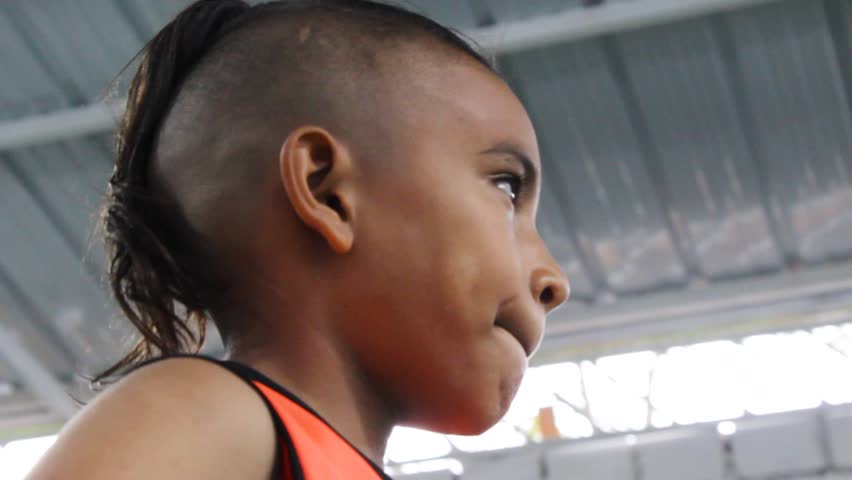 Portrait of a Latino soccer player in a white uniform training inside a gym in Neiva, Huila, Colombia. Childhood and sports concept