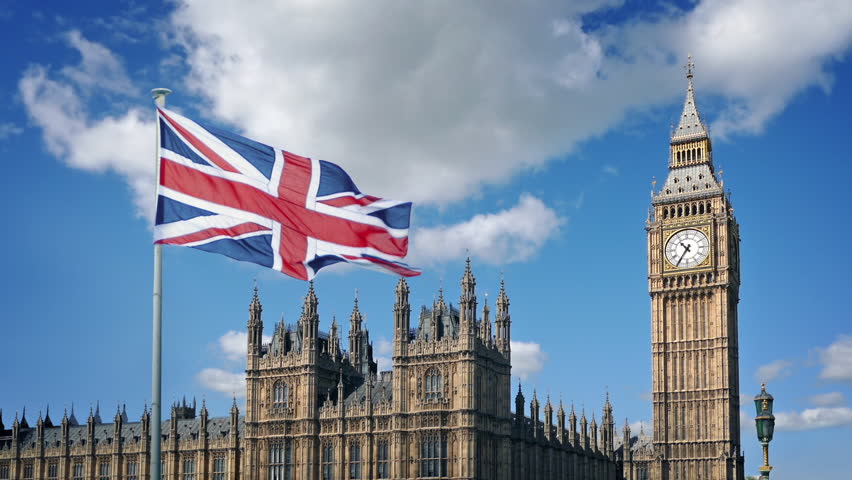 British Flag And Houses Of Parliament On Sunny Day
