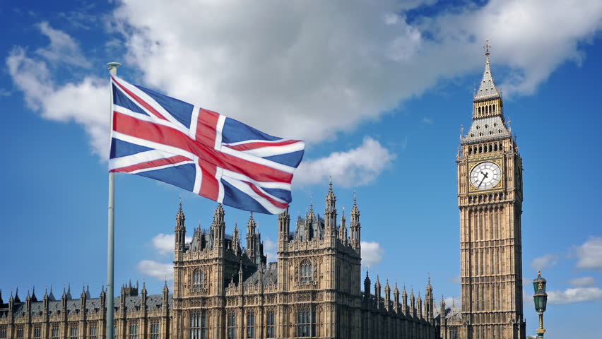 British Flag And Houses Of Parliament On Sunny Day
