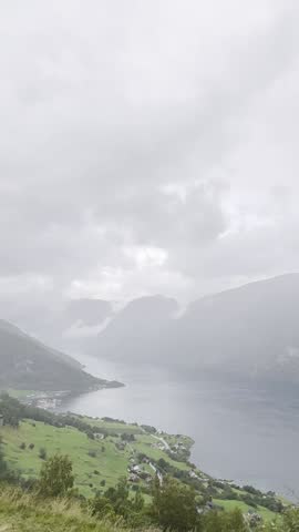 Majestic Norwegian fjords captured from a boat, from the road, and from above, under sun and rain.