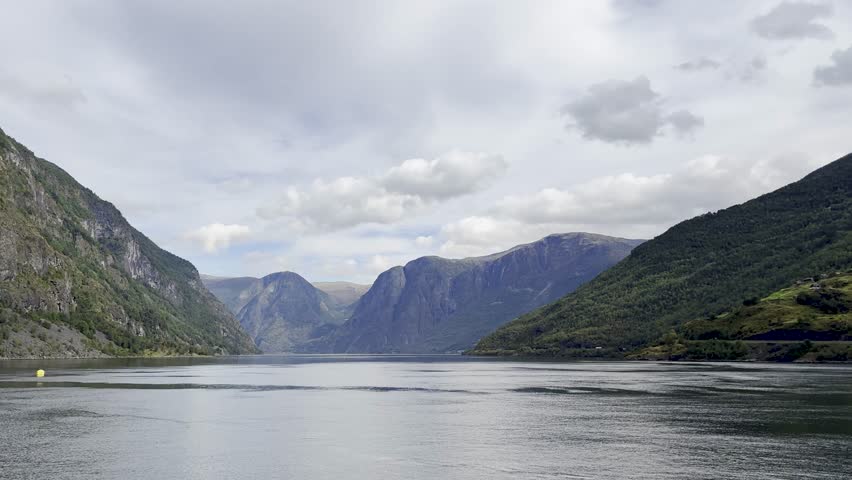Majestic Norwegian fjords captured from a boat, from the road, and from above, under sun and rain.